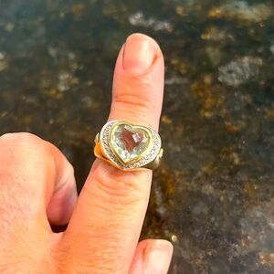 Solid 14kt gold ring featuring a green amethyst heart surrounded by diamonds.